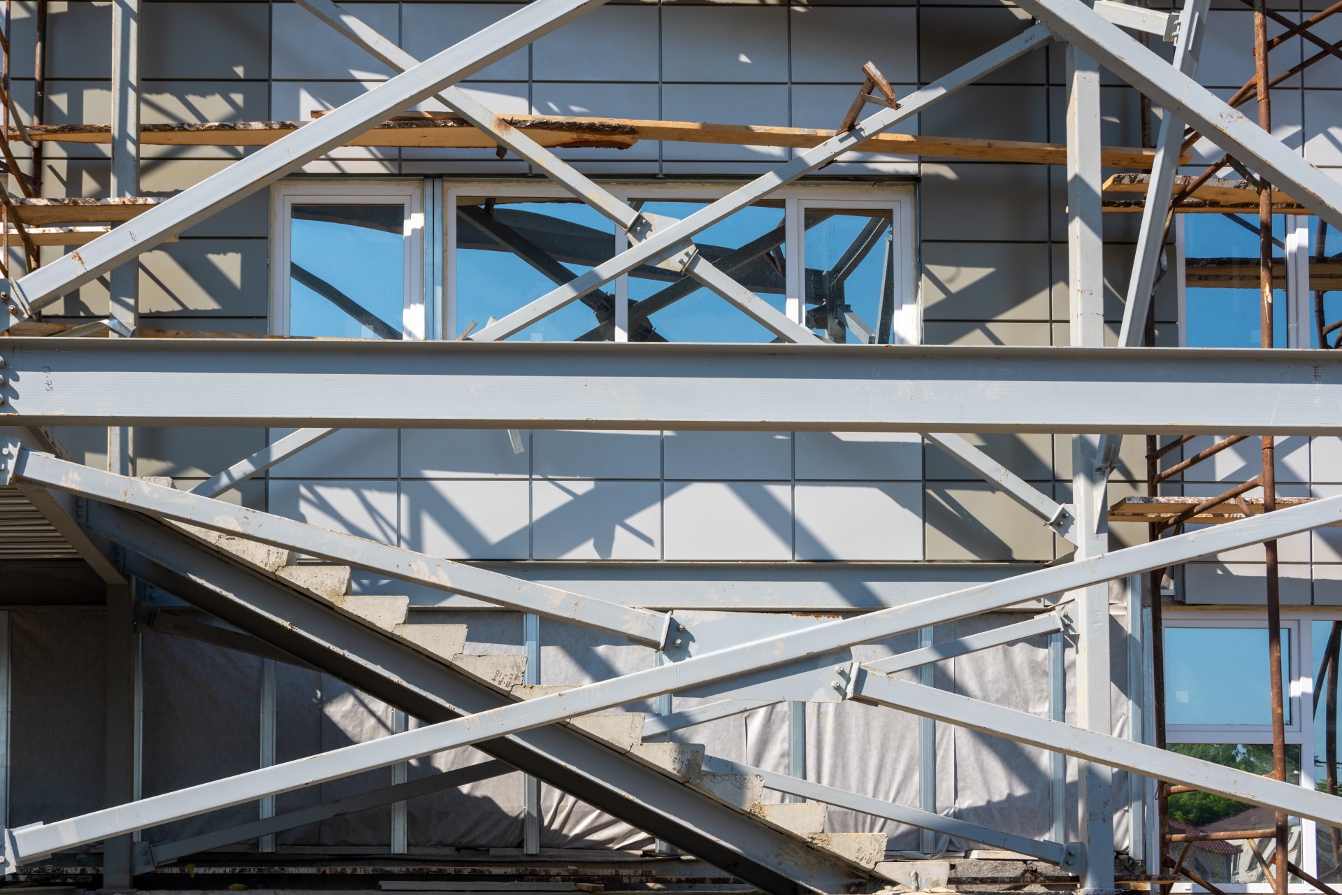 Building under construction. Fragment of scaffolding against house wall. Residential houses under construction.